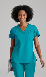 Load image into Gallery viewer, Racer Top by Barco One/ 4 Pocket V-Neck Breathable Scrub Top - Scrub Hub
